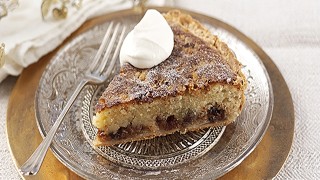 Christmas Frangipane Tart served on a silver plate with a dollop of cream on top