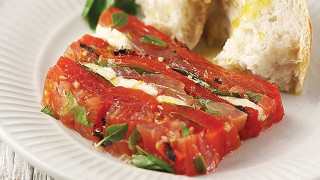 English Tomato and Burnt Red Pepper Terrine served on a white plate with a piece of crusty bread