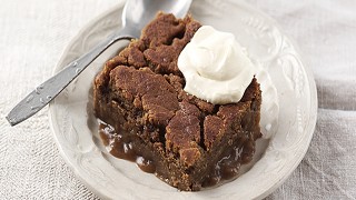 Gingerbread Pudding with Eggnog Cream served in a white dish as a single portion