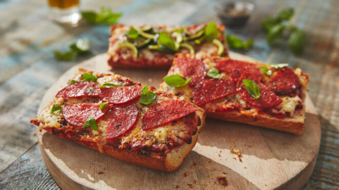 pizza breads topped with pizza sauce, mozzarella and chorizo