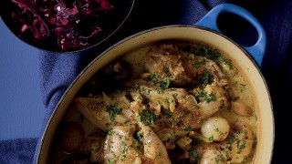 The Moorland Game Pot served in a blue casserole dish next to a bowl of red cabbage