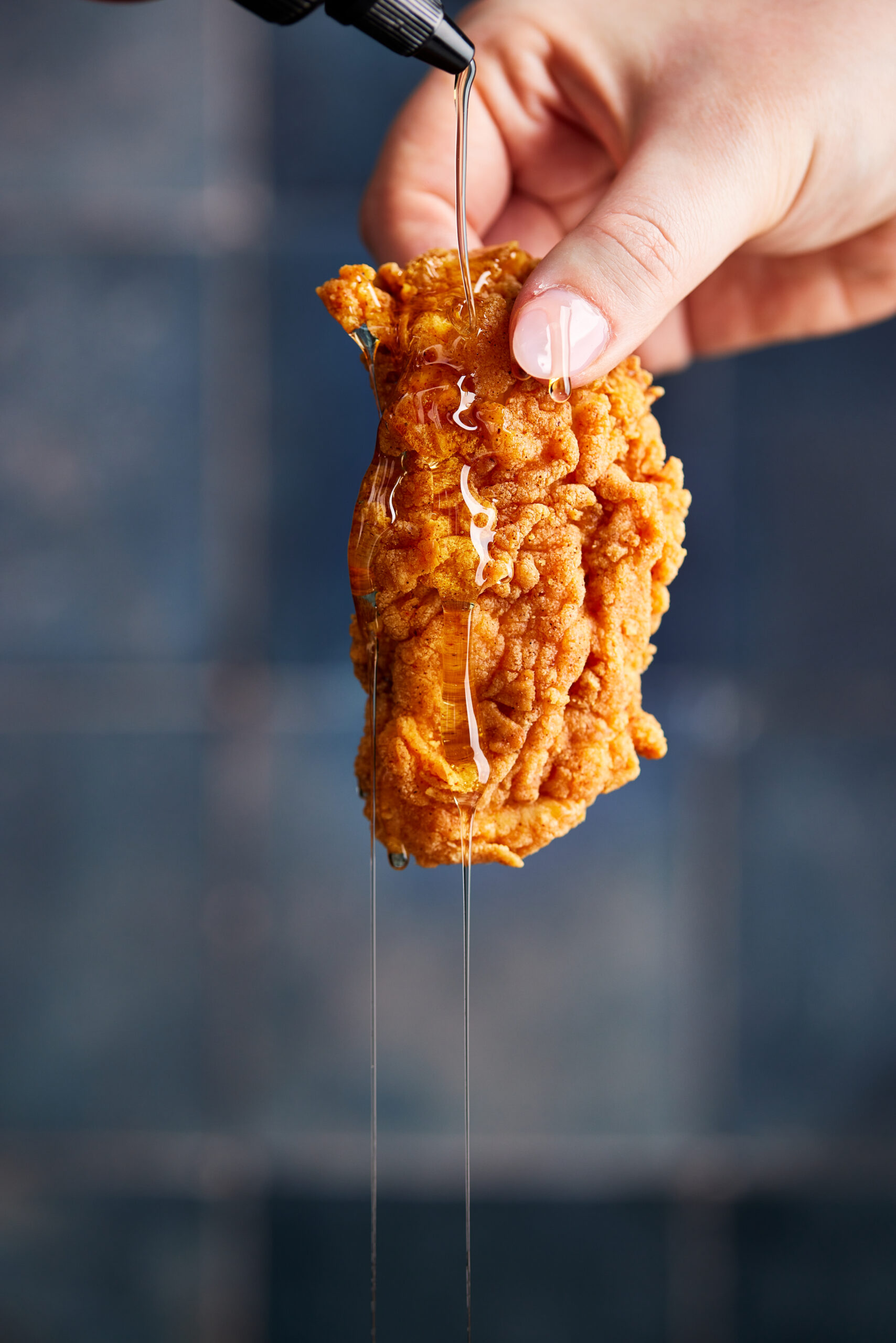 Honey dripped over fried chicken.