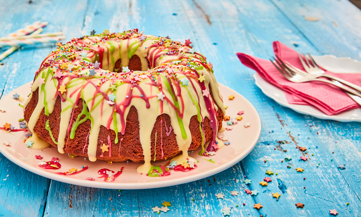 Chocolate Rainbow Cake decorated with white chocolate, coloured chocolate and sprinkles