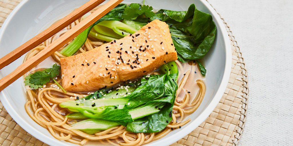 Lapsang Souchong Poached Salmon served in a white bowl with chopsticks and toppped with sesame and nigella seeds