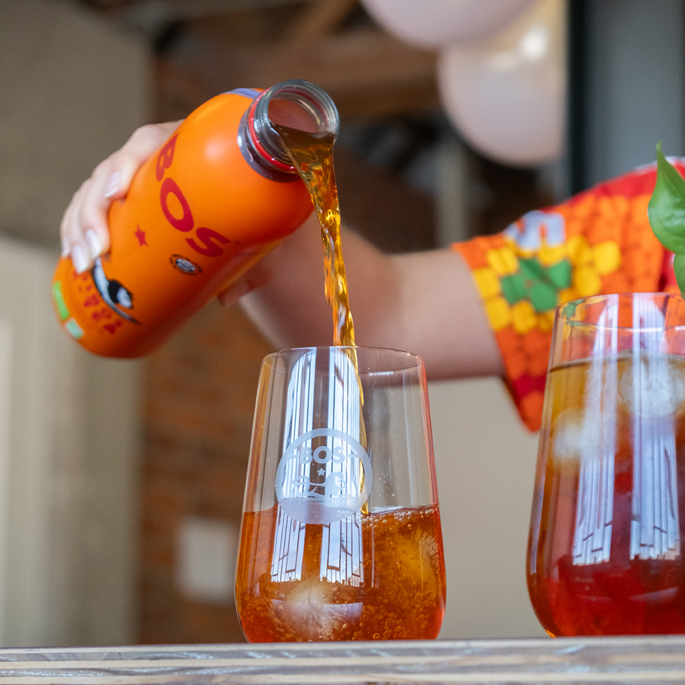 Bos Rooibos Peach Ice Tea being poured into a glass.