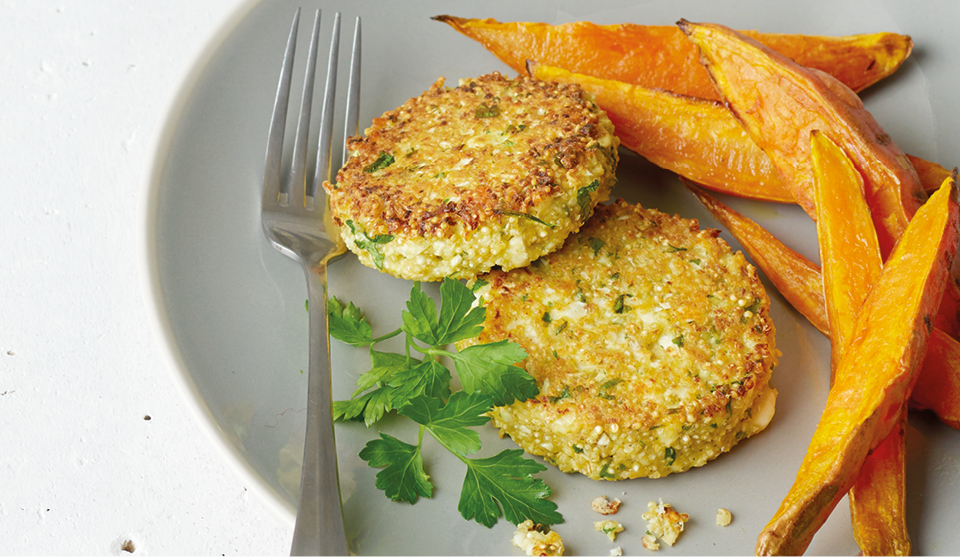 Quinoa Patties with Cauliflower and Feta served on a grey plate with sweet potato wedges