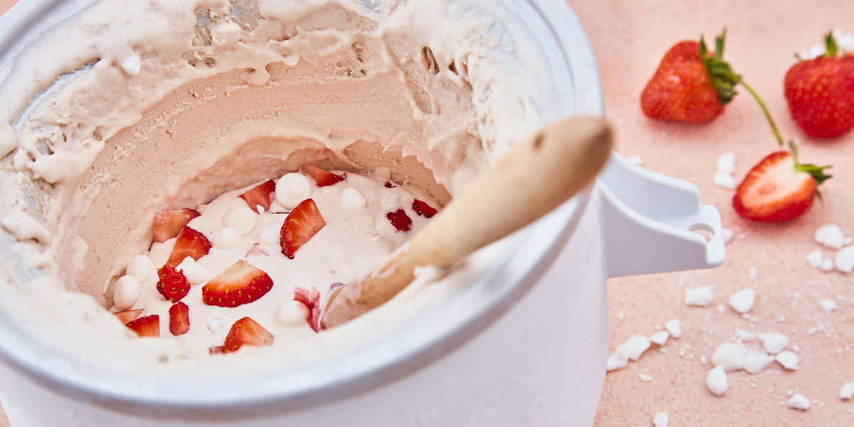 Strawberry Meringue Ice Cream served in a frozen bowl and sliced strawberries