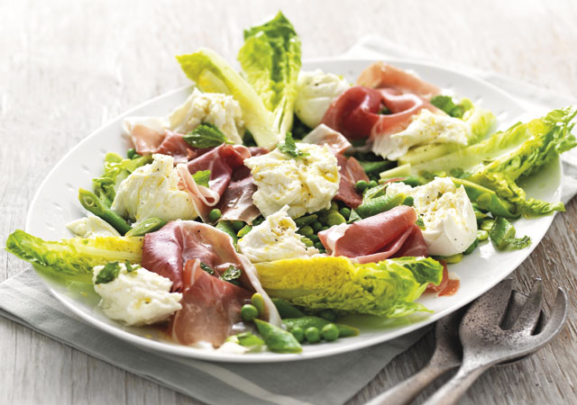 Summer Green Salad with Mozzarella and Parma Ham served on a white plate