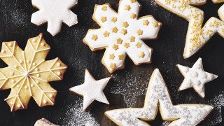 Vanilla Christmas Cookies in the shapes of stars and snowflakes, dusted with icing sugar and decorated with icing